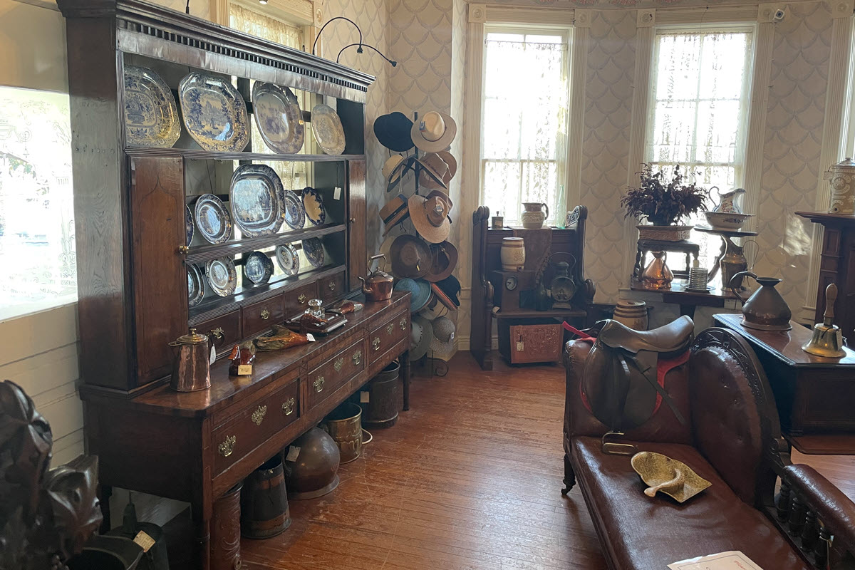 Large Antique Display with plates, and hats and other items.